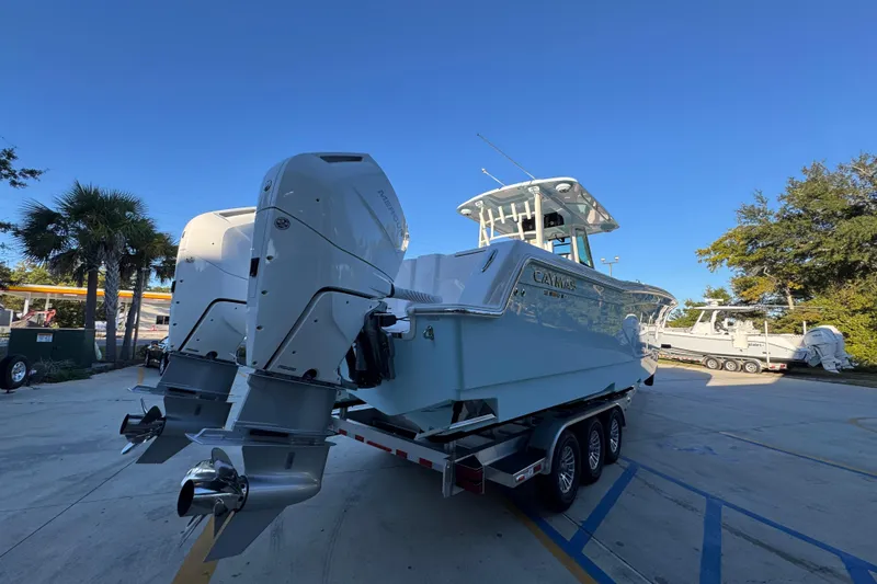 Slide: The Image of 2026 Caymas 34 CT boat with dual outboard engines on a trailer. - 9