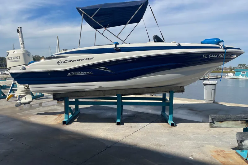 Slide: The Image of 2019 Crownline Eclipse E205 XS boat on a lift at a marina. - 1