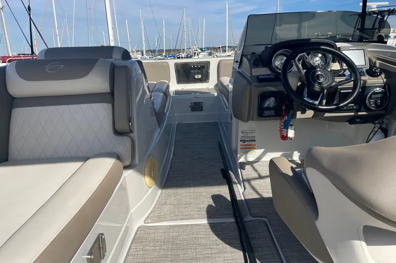 Slide: The Image of 2019 Crownline Eclipse E205 XS boat interior with steering wheel and seating. - 11