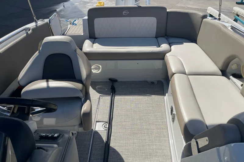 Slide: The Image of 2019 Crownline Eclipse E205 XS boat interior with beige seating and steering wheel. - 16