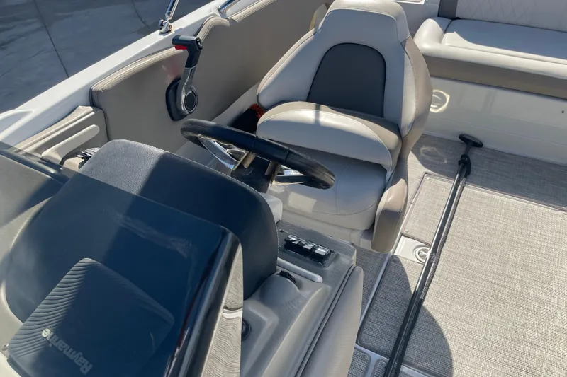 Slide: The Image of 2019 Crownline Eclipse E205 XS boat interior with steering wheel and seating. - 18