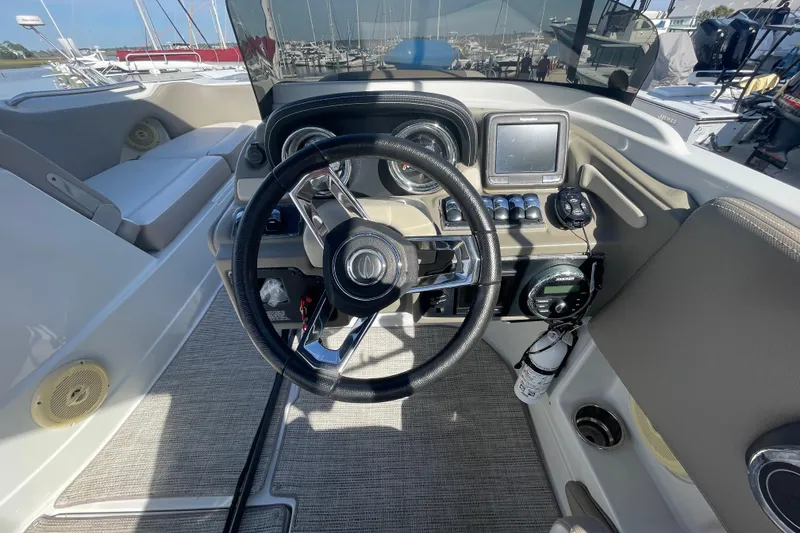 Slide: The Image of 2019 Crownline Eclipse E205 XS boat cockpit with steering wheel and control panel. - 19