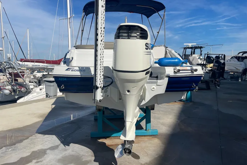 Slide: The Image of 2019 Crownline Eclipse E205 XS boat with outboard motor in marina setting. - 24