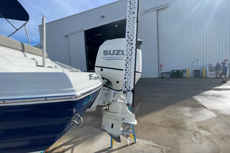 Slide: The Image of 2019 Crownline Eclipse E205 XS boat with Suzuki outboard motor at a marina. - 28