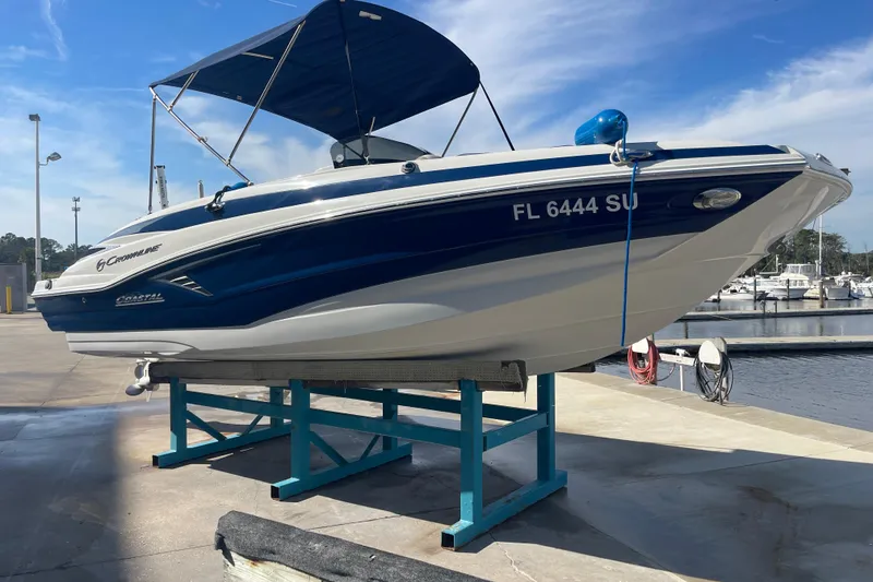 Slide: The Image of 2019 Crownline Eclipse E205 XS boat on a dock with blue canopy. - 3
