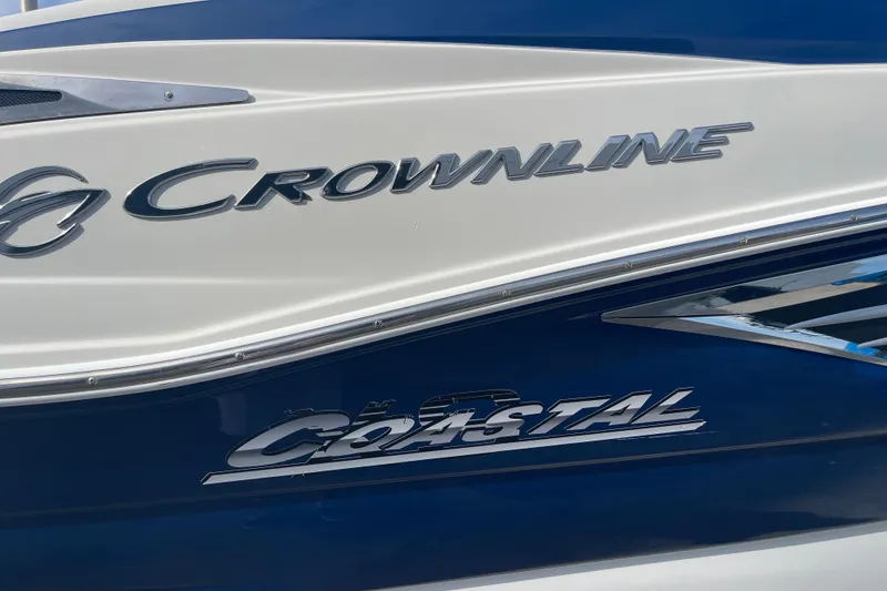Slide: The Image of 2019 Crownline Eclipse E205 XS boat with "Coastal" branding on the side. - 5