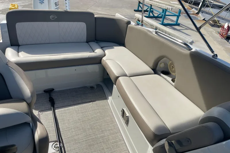 Slide: The Image of 2019 Crownline Eclipse E205 XS boat interior with gray seating and carpeted floor. - 9