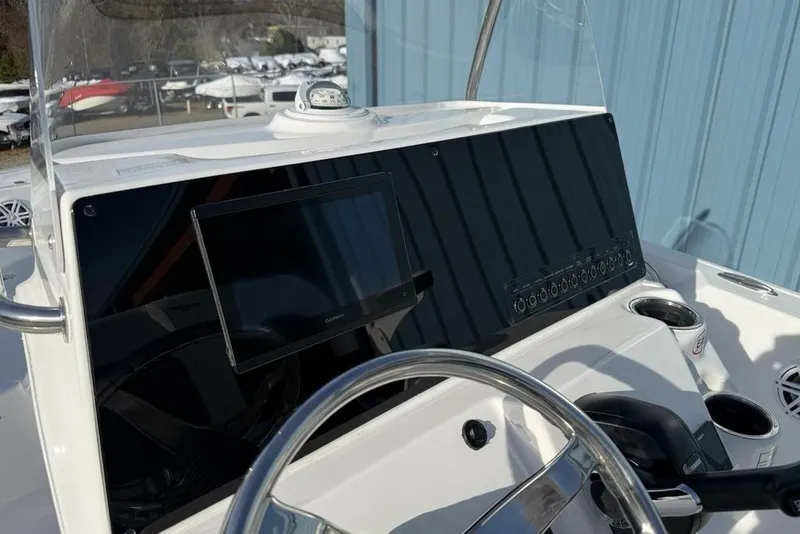 Slide: The Image of 2026 Tidewater 198 CC Adventure boat dashboard with steering wheel and navigation display. - 10