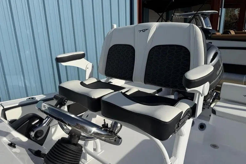 Slide: The Image of 2026 Tidewater 198 CC Adventure boat seats with steering wheel, featuring modern design. - 11