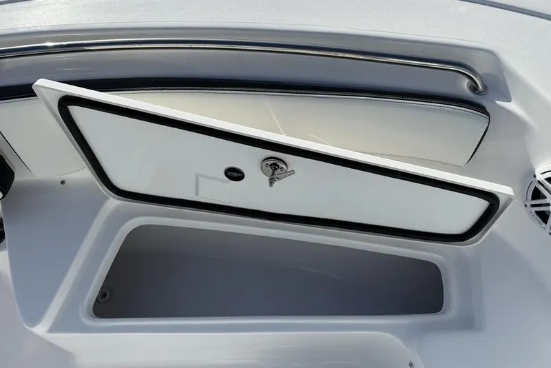 Slide: The Image of 2026 Tidewater 198 CC Adventure boat storage compartment with open hatch and sleek design. - 12