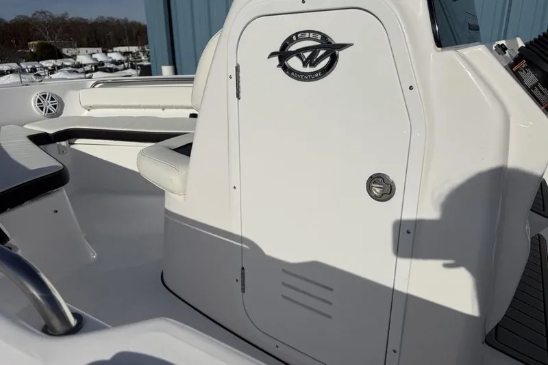 Slide: The Image of 2026 Tidewater 198 CC Adventure boat interior with seating and storage compartment. - 17
