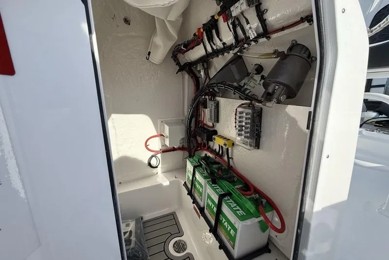 Slide: The Image of 2026 Tidewater 198 CC Adventure boat electrical compartment with batteries and wiring. - 24