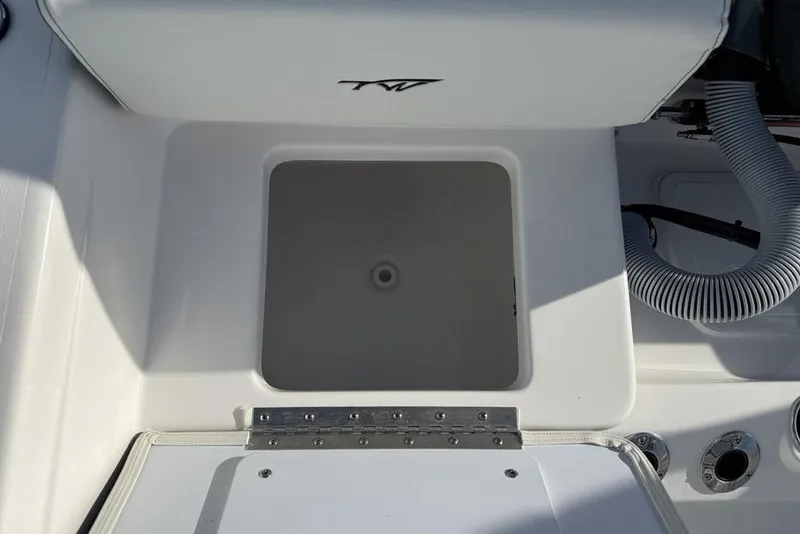 Slide: The Image of 2026 Tidewater 198 CC Adventure boat storage compartment with hose and fittings. - 27