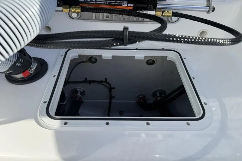 Slide: The Image of 2026 Tidewater 198 CC Adventure boat interior compartment with visible wiring and components. - 29