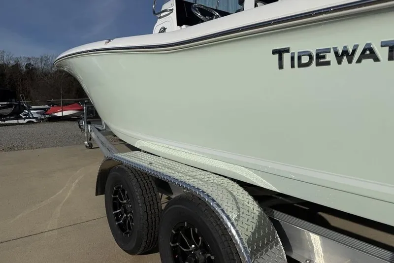 Slide: The Image of 2026 Tidewater 198 CC Adventure boat on trailer, side view with logo visible. - 3