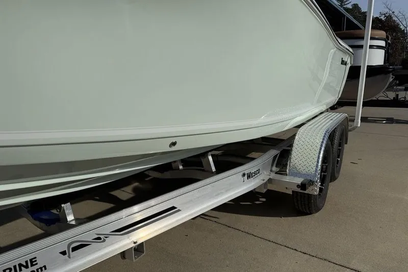 Slide: The Image of 2026 Tidewater 198 CC Adventure boat on a Wesco trailer, side view. - 5