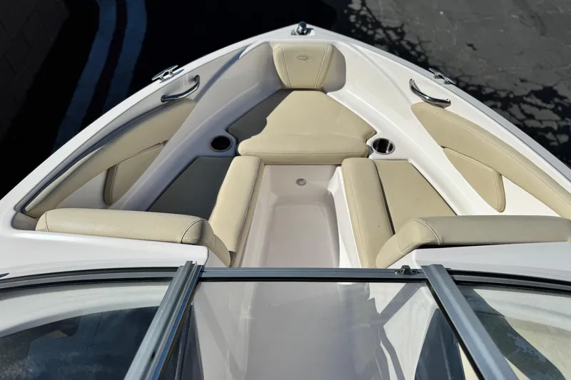 Slide: The Image of 2020 Regal 1900 ES Bowrider boat interior with beige seating and cup holders. - 11