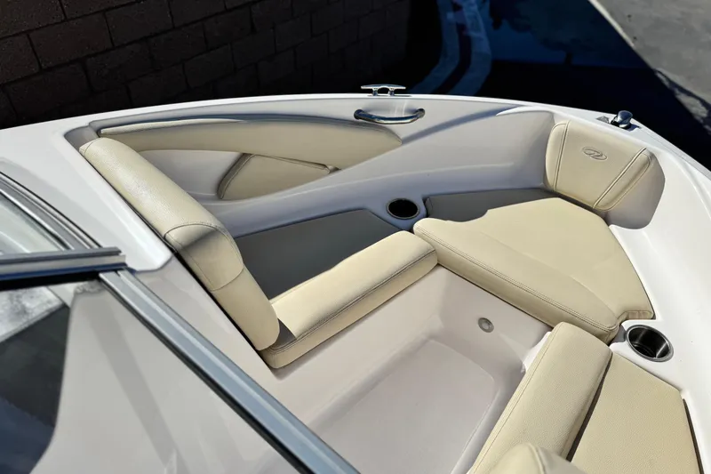 Slide: The Image of 2020 Regal 1900 ES Bowrider interior with beige seating and cup holders. - 12