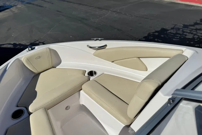Slide: The Image of 2020 Regal 1900 ES Bowrider boat interior with beige seating and cup holders. - 13