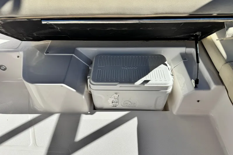 Slide: The Image of 2020 Regal 1900 ES Bowrider storage compartment with Igloo cooler. - 16