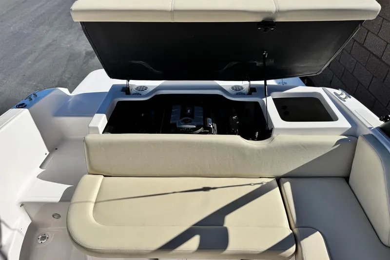 Slide: The Image of 2020 Regal 1900 ES Bowrider boat with open engine compartment and seating area. - 17