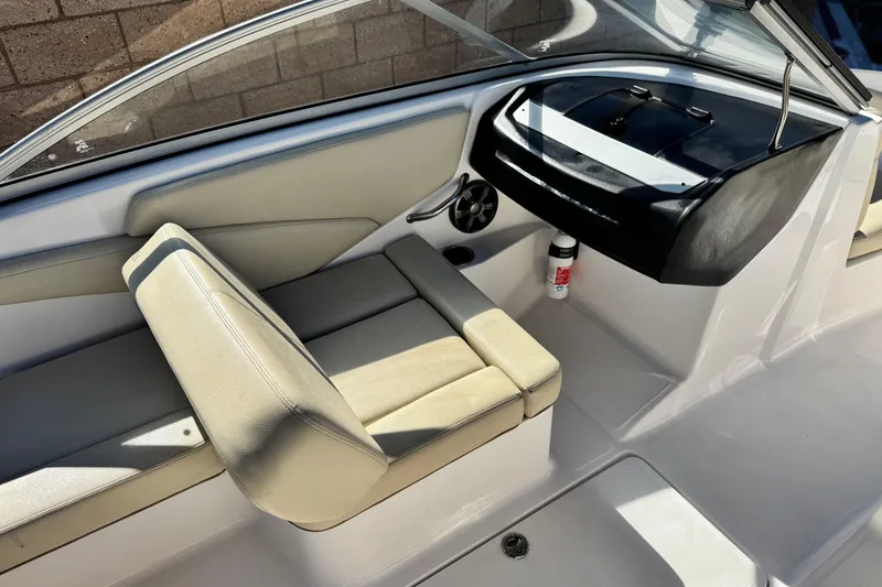 Slide: The Image of 2020 Regal 1900 ES Bowrider interior with beige seating and dashboard view. - 19