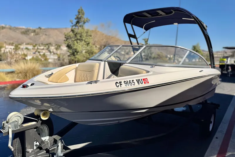 Slide: The Image of 2020 Regal 1900 ES Bowrider boat on trailer, parked outdoors. - 3