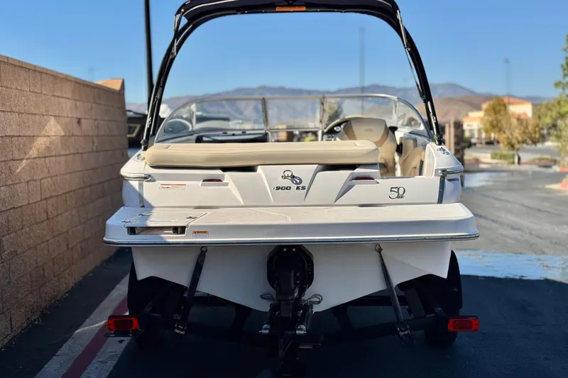 Slide: The Image of 2020 Regal 1900 ES Bowrider boat, rear view, parked outdoors. - 4