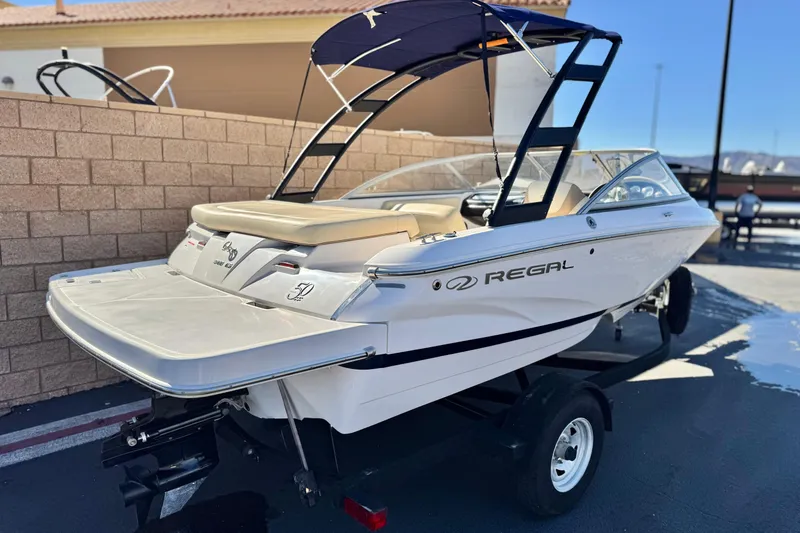 Slide: The Image of 2020 Regal 1900 ES Bowrider boat with trailer, parked outdoors. - 5