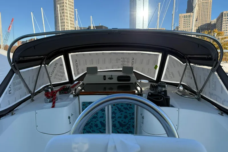 Slide: The Image of Interior view of 2006 Hunter 41 Deck Salon sailboat cockpit with city skyline backdrop. - 10