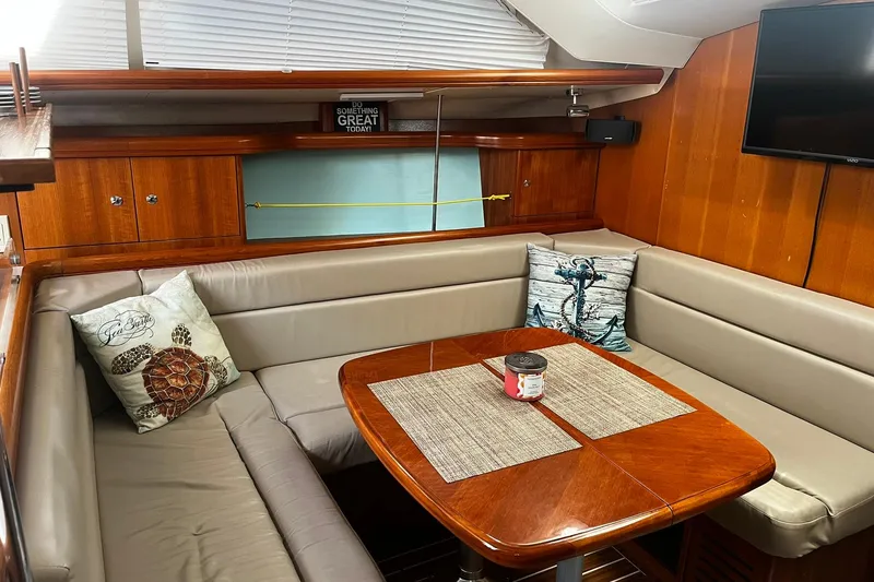 Slide: The Image of Cozy interior of 2006 Hunter 41 Deck Salon with dining area and nautical decor. - 14