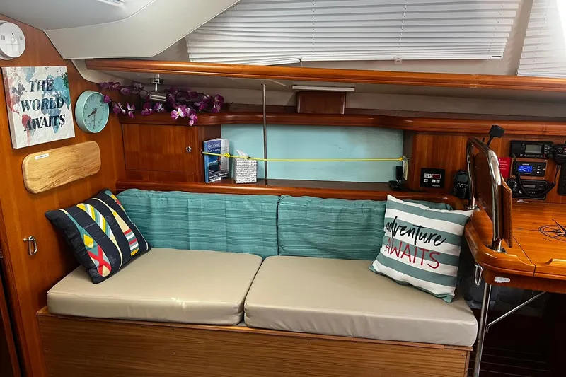 Slide: The Image of Cozy interior of 2006 Hunter 41 Deck Salon with nautical decor and cushions. - 15
