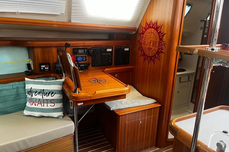 Slide: The Image of Interior of 2006 Hunter 41 Deck Salon with navigation station and cozy seating area. - 16
