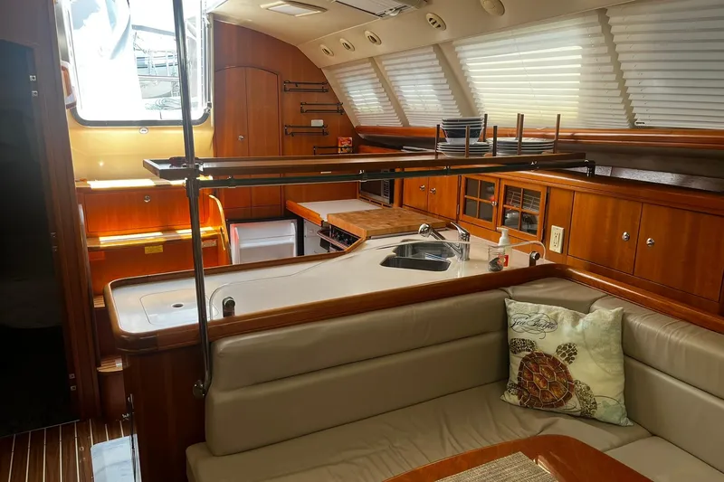 Slide: The Image of Interior of 2006 Hunter 41 Deck Salon yacht with modern kitchen and seating area. - 17