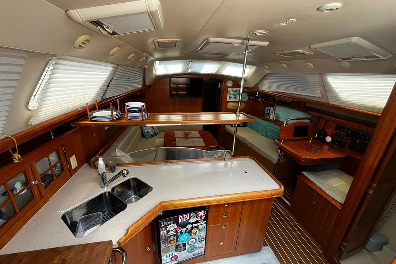 Slide: The Image of Interior of 2006 Hunter 41 Deck Salon yacht with modern kitchen and cozy seating area. - 18