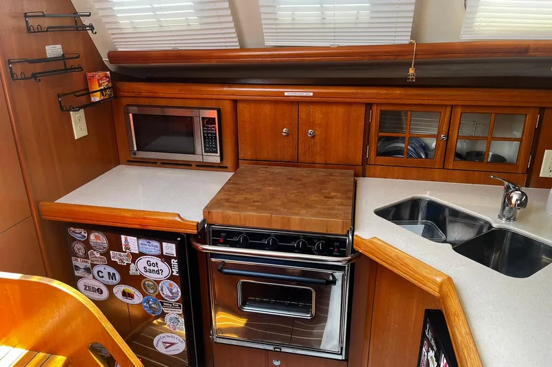 Slide: The Image of Galley kitchen in 2006 Hunter 41 Deck Salon yacht with microwave, stove, and sink. - 19