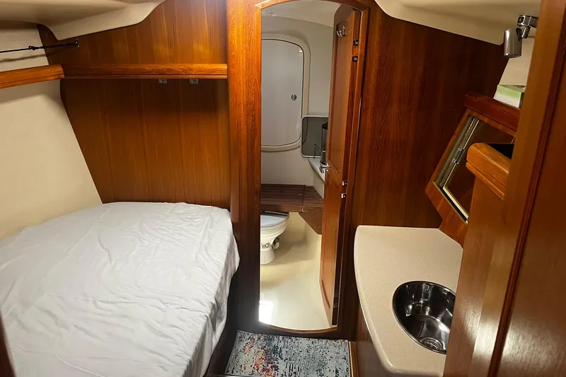 Slide: The Image of Interior of 2006 Hunter 41 Deck Salon with bed, sink, and bathroom. - 21