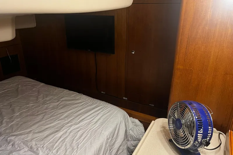 Slide: The Image of Interior of 2006 Hunter 41 Deck Salon with bed, fan, and TV. - 26
