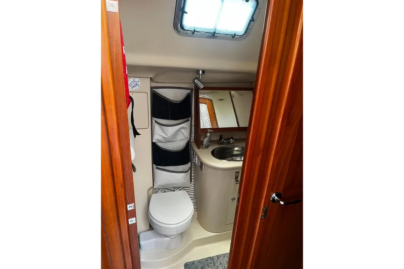 Slide: The Image of Bathroom interior of 2006 Hunter 41 Deck Salon yacht, featuring toilet and sink. - 30