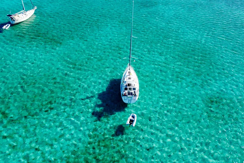 Slide: The Image of Aerial view of 2006 Hunter 41 Deck Salon sailboat on clear turquoise water. - 6