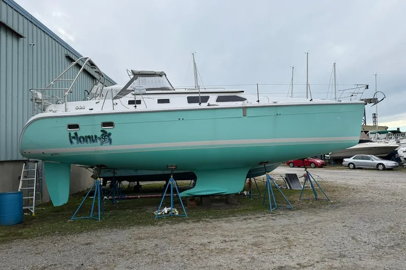 Slide: The Image of 2006 Hunter 41 Deck Salon sailboat in dry dock, turquoise hull, named "Honu." - 7