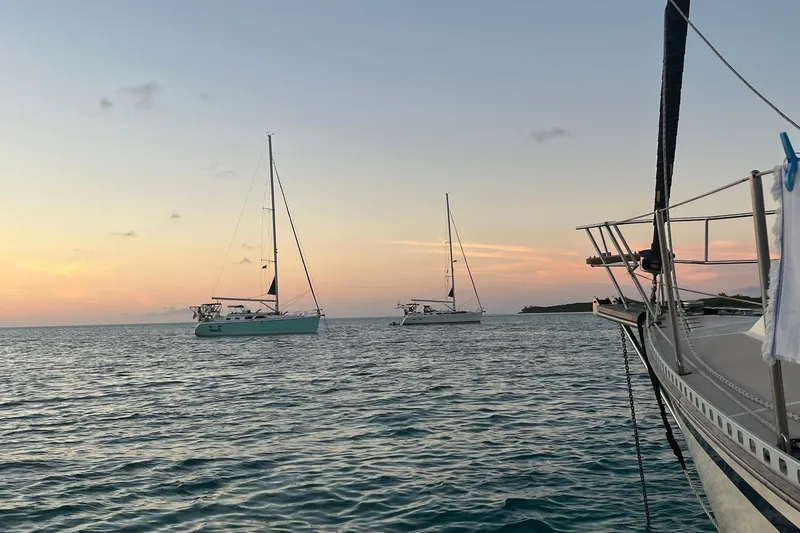 Slide: The Image of Sailboats on calm sea at sunset, featuring a 2006 Hunter 41 Deck Salon. - 8