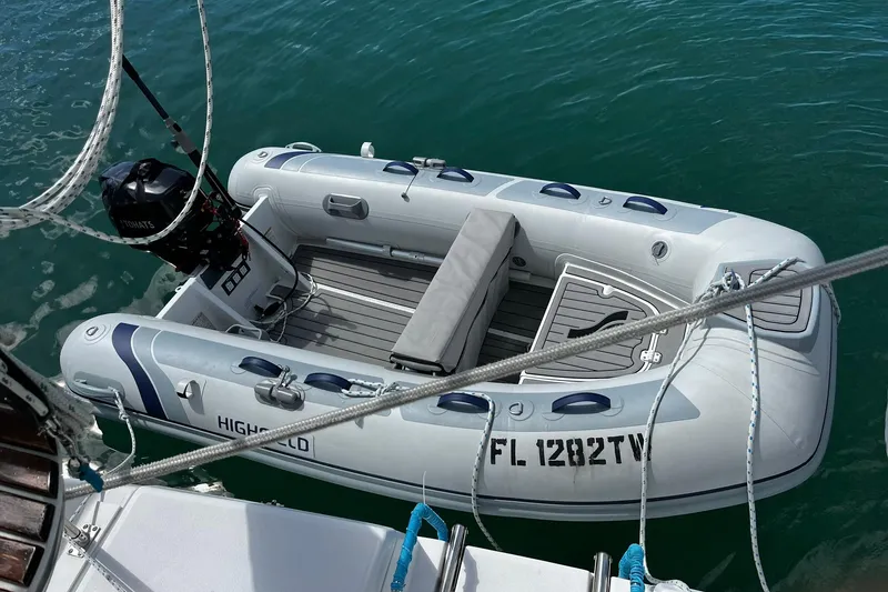 Slide: The Image of Inflatable boat with outboard motor, docked beside a 2006 Hunter 41 Deck Salon. - 9
