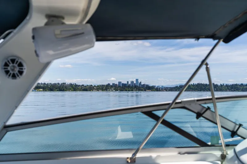 Slide: The Image of View from 1998 Avanti 4085 Sunbridge boat, overlooking a serene lake and distant city skyline. - 14