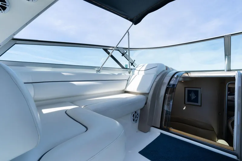 Slide: The Image of Luxurious interior of 1998 Avanti 4085 Sunbridge yacht with white seating and blue sky view. - 16