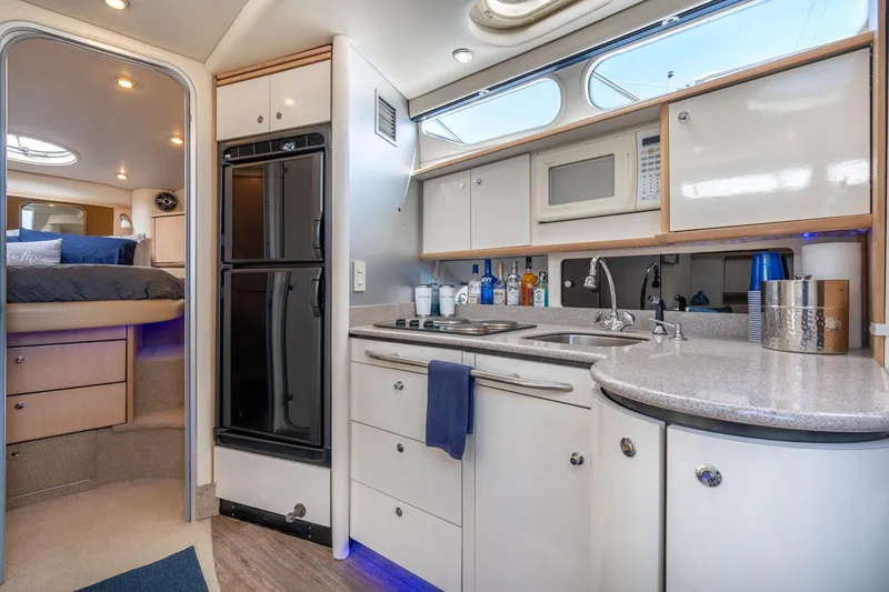 Slide: The Image of Luxurious 1998 Avanti 4085 Sunbridge yacht interior with modern kitchen and cozy bedroom. - 21