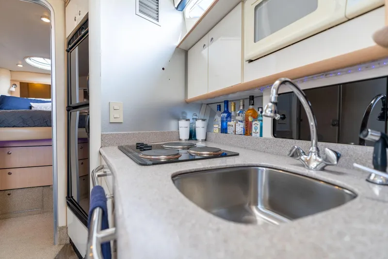 Slide: The Image of 1998 Avanti 4085 Sunbridge yacht kitchen with sink, stove, and storage cabinets. - 22