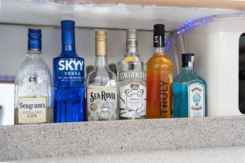 Slide: The Image of Bottles of assorted spirits on a 1998 Avanti 4085 Sunbridge boat counter. - 23