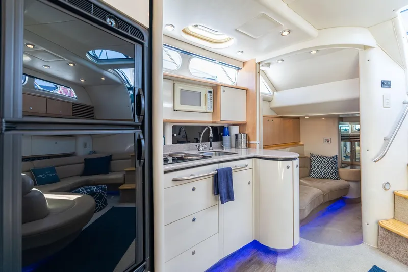 Slide: The Image of Luxurious interior of a 1998 Avanti 4085 Sunbridge yacht with modern kitchen and seating area. - 28