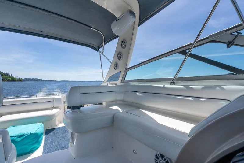 Slide: The Image of 1998 Avanti 4085 Sunbridge yacht interior with white seating and scenic water view. - 32